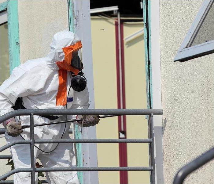 An asbestos abatement contractor in PPE