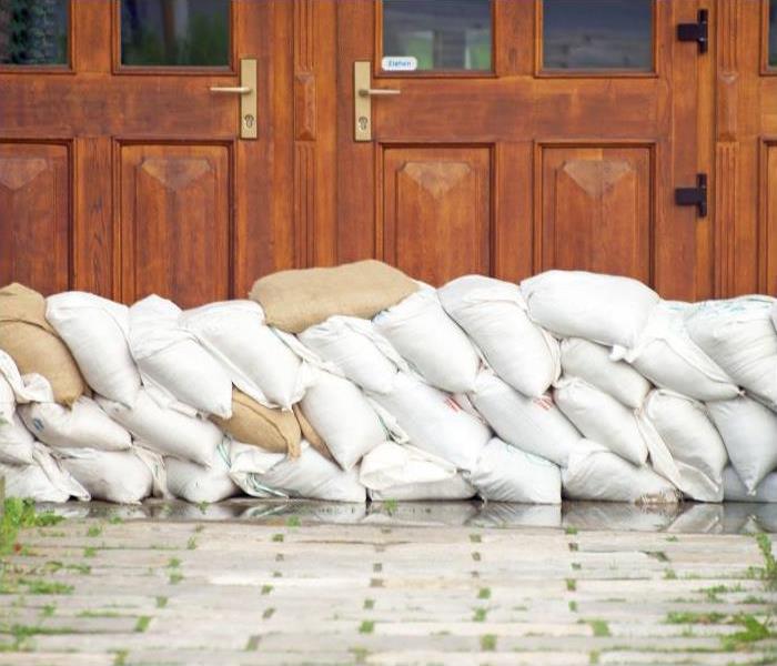 sandbags placed in front of a door to prevent flood damage.