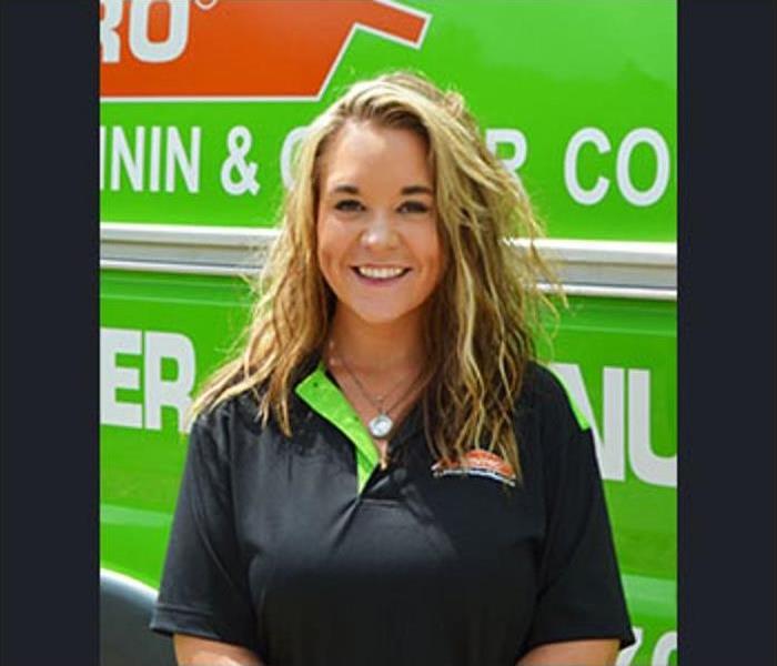 Female General Manager Christine Osborn standing in front of SERVPRO truck 